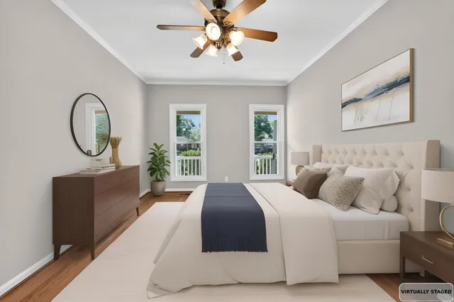 a bedroom with bed and a chandelier
