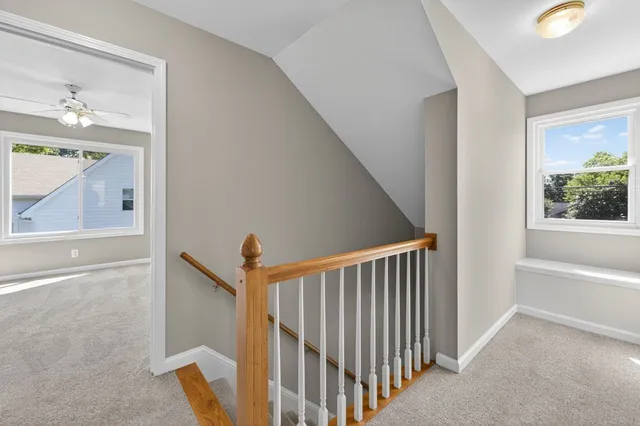 a view of a hallway with entryway window and front door