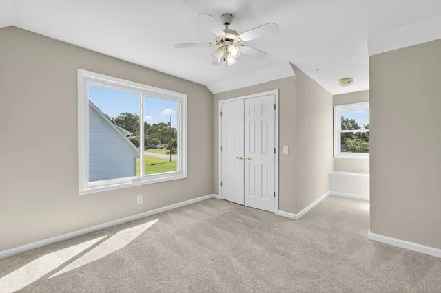 a view of an empty room with a ceiling fan
