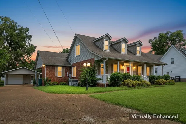 a front view of house with yard and green space