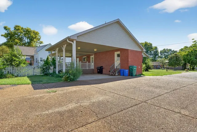 a backyard of a house with yard and outdoor seating