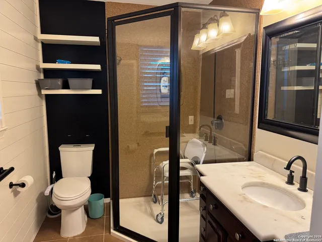 a bathroom with a toilet sink and shower