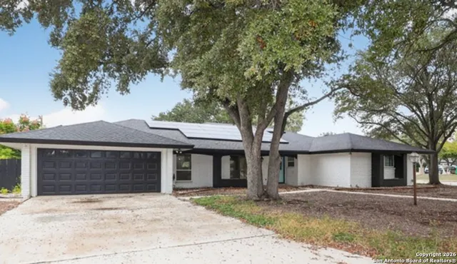 front view of a house with a tree