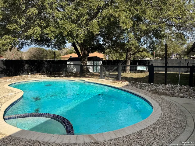 a swimming pool with outdoor seating and yard