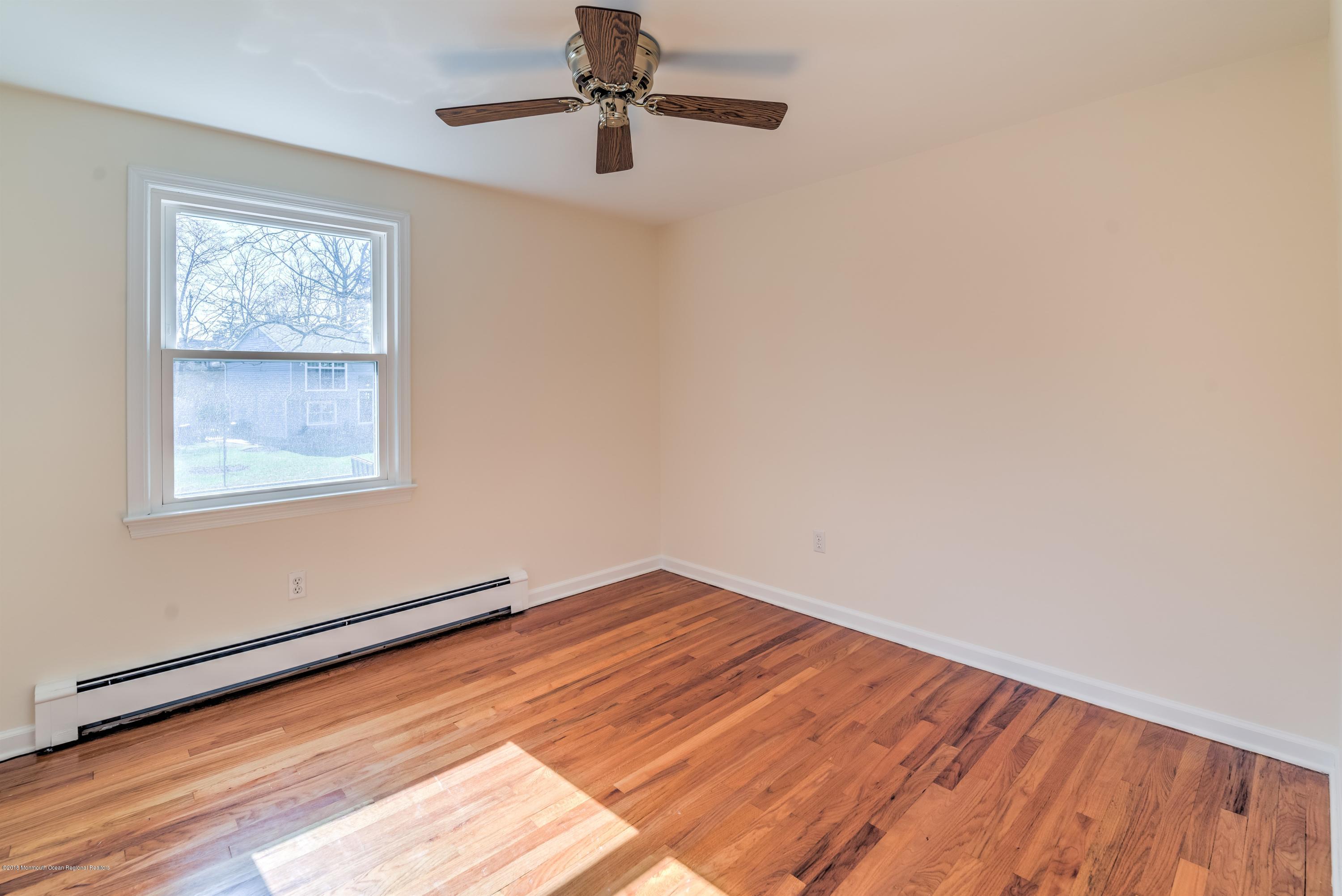 2 Ruddy Court Little Silver, NJ 07739 - Photo 13 of 19 a view of empty room with wooden floor and fan