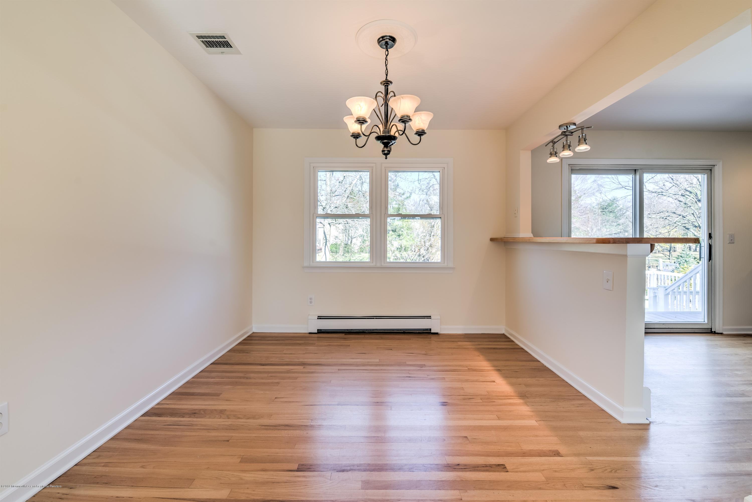2 Ruddy Court Little Silver, NJ 07739 - Photo 5 of 19 an empty room with wooden floor chandelier and windows