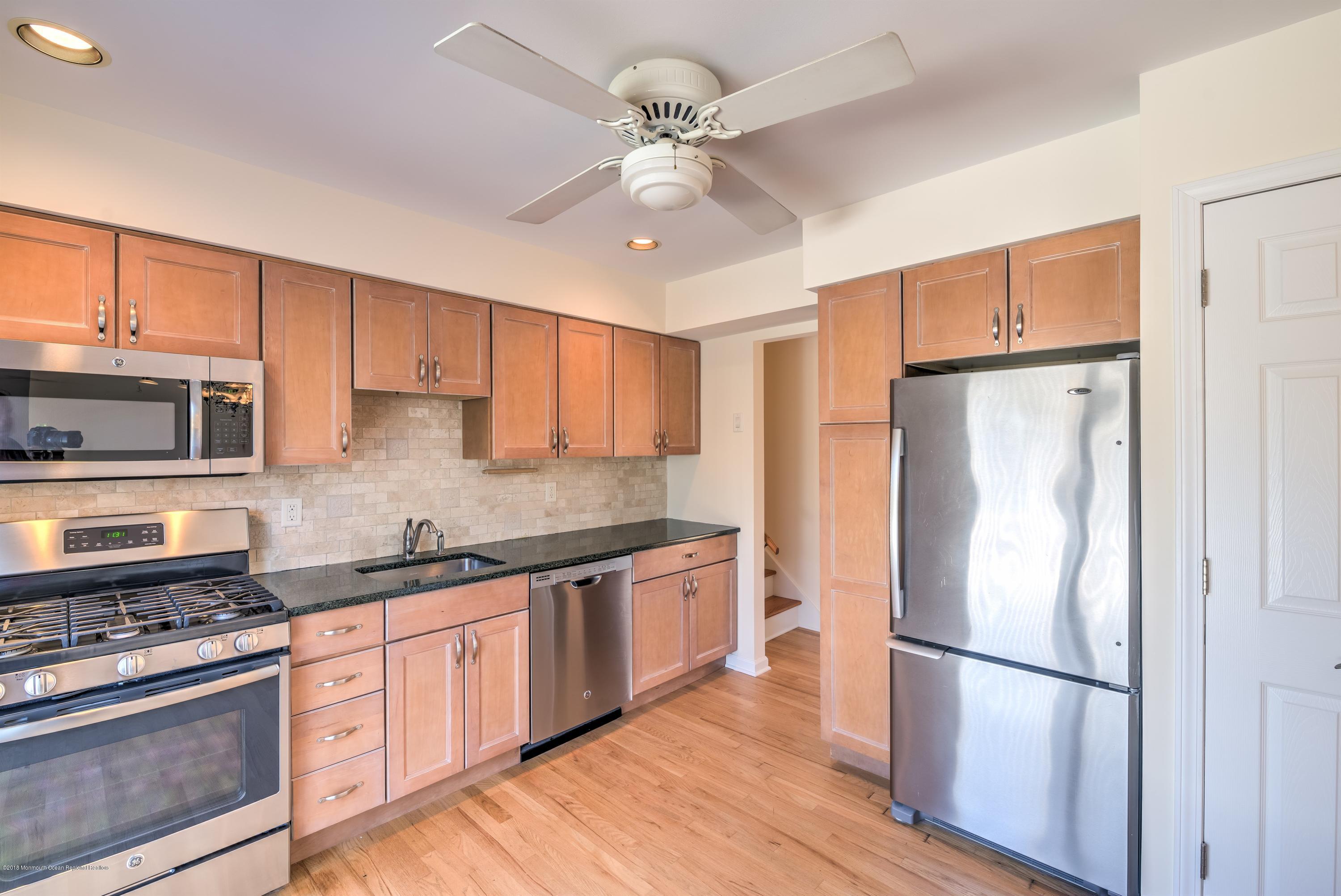 2 Ruddy Court Little Silver, NJ 07739 - Photo 7 of 19 a kitchen with stainless steel appliances granite countertop a refrigerator stove a sink and dishwasher with wooden floor