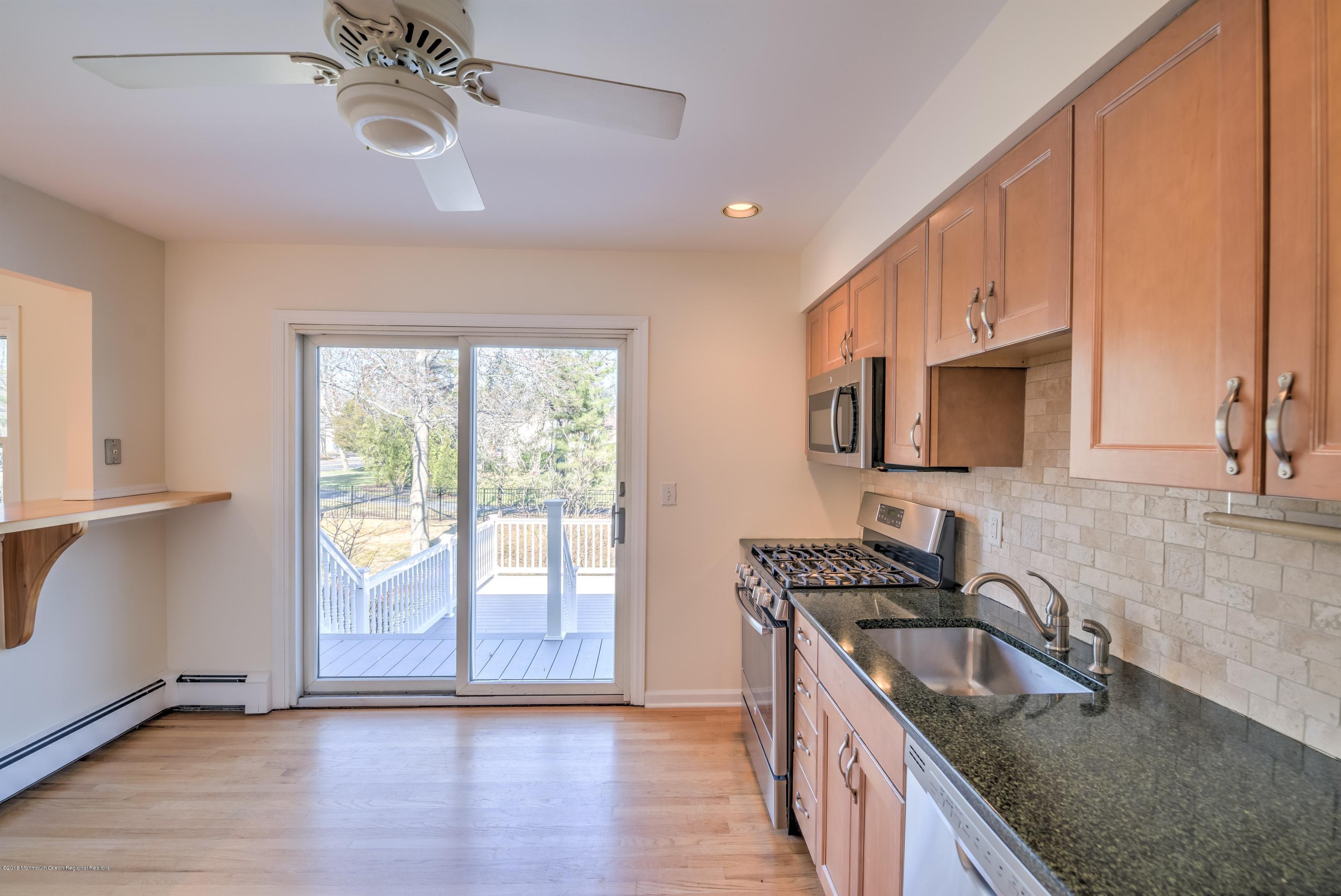 2 Ruddy Court Little Silver, NJ 07739 - Photo 8 of 19 a kitchen with granite countertop a sink appliances cabinets and a large window