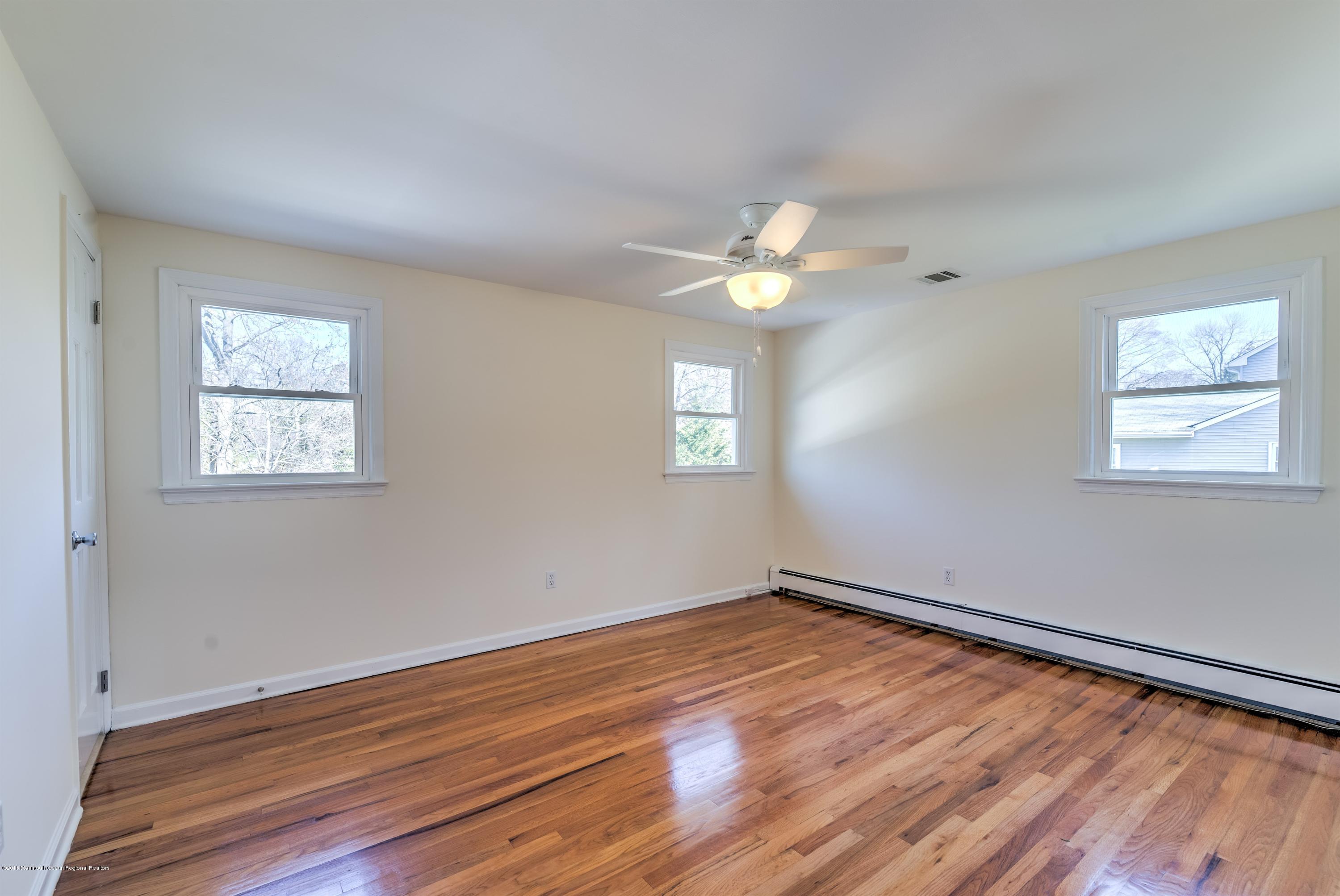 2 Ruddy Court Little Silver, NJ 07739 - Photo 9 of 19 a view of an empty room with wooden floor and a window