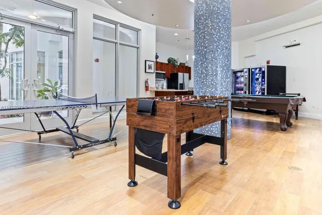 a room with furniture pool table and windows