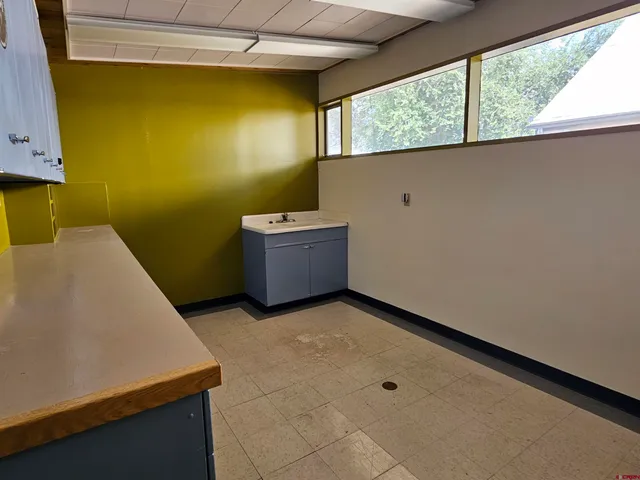a work room with furniture and a table