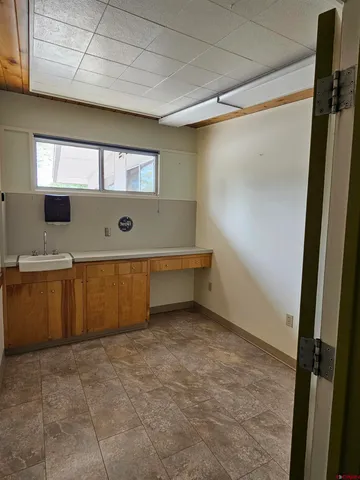 a kitchen with sink cabinets and a wooden floor