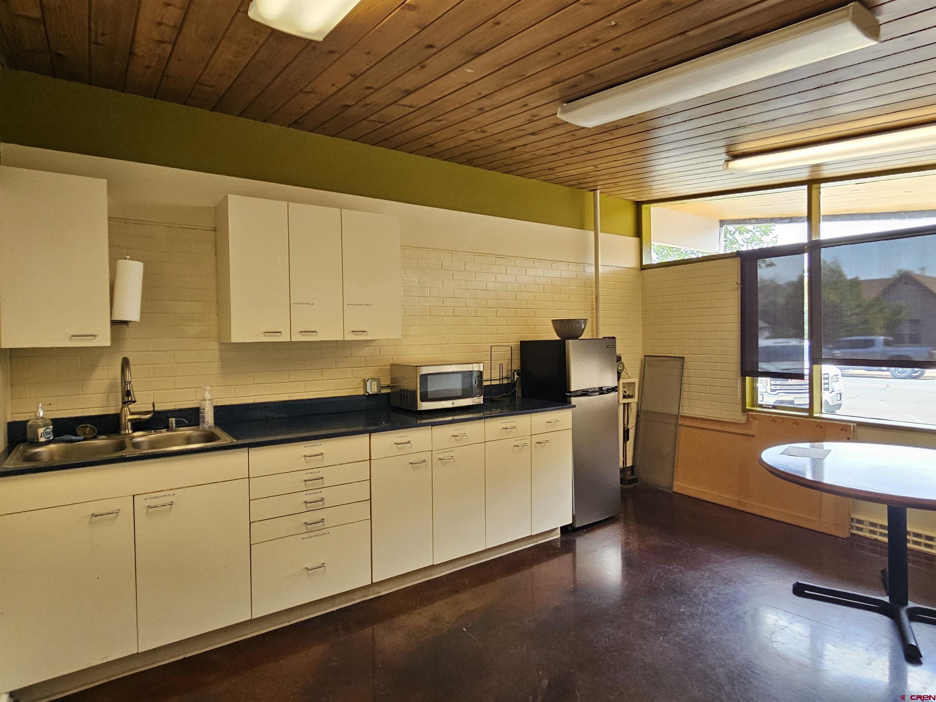 555 Meeker Street Delta, CO 81416 - Photo 10 of 19 a kitchen with sink cabinets and a wooden floor
