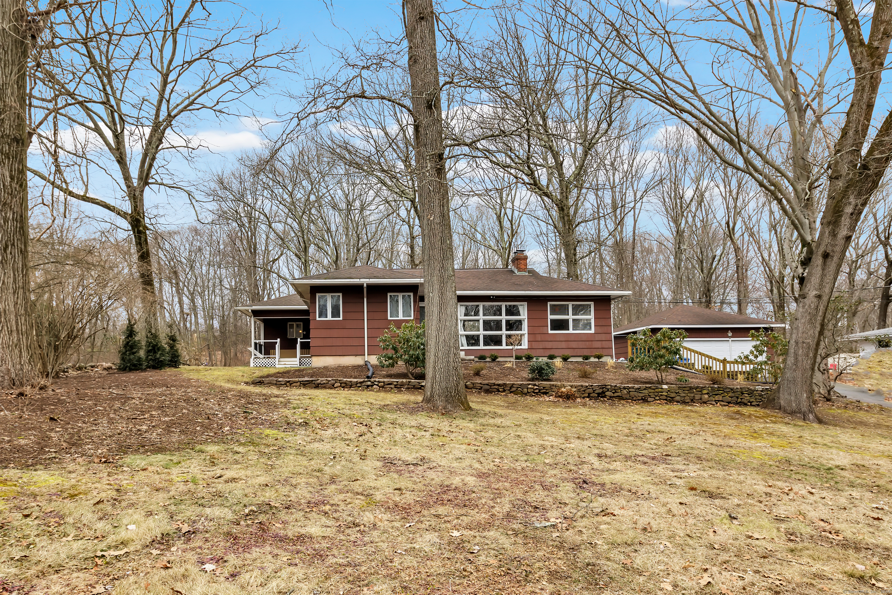 a house that has a tree in front of it