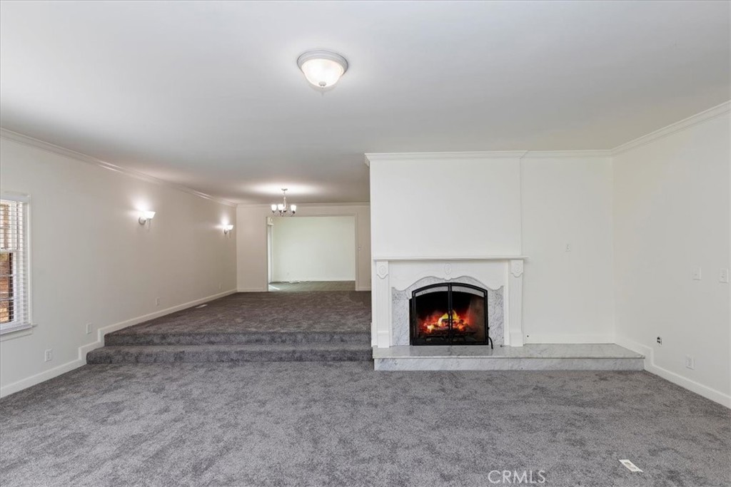 2154 Gainsborough Drive Riverside, CA 92506 - Photo 15 of 43 a view of an empty room with a fireplace and window