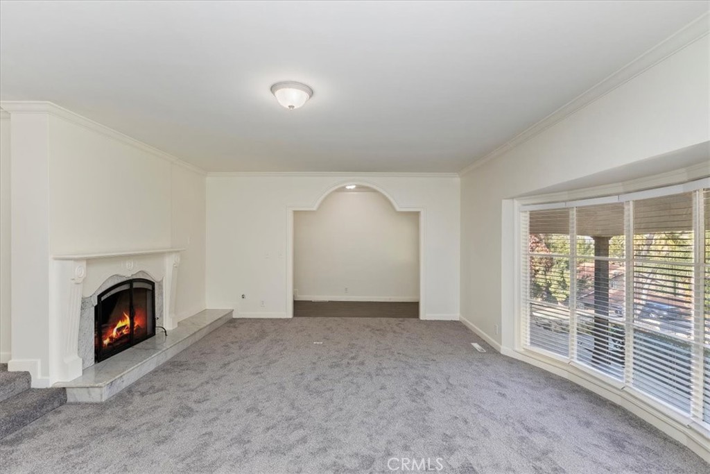 2154 Gainsborough Drive Riverside, CA 92506 - Photo 17 of 43 a view of empty room with fireplace and fan