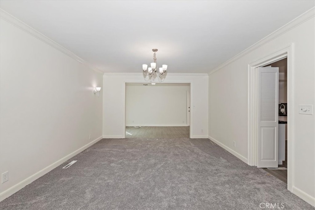 2154 Gainsborough Drive Riverside, CA 92506 - Photo 18 of 43 a view of an empty room with a chandelier