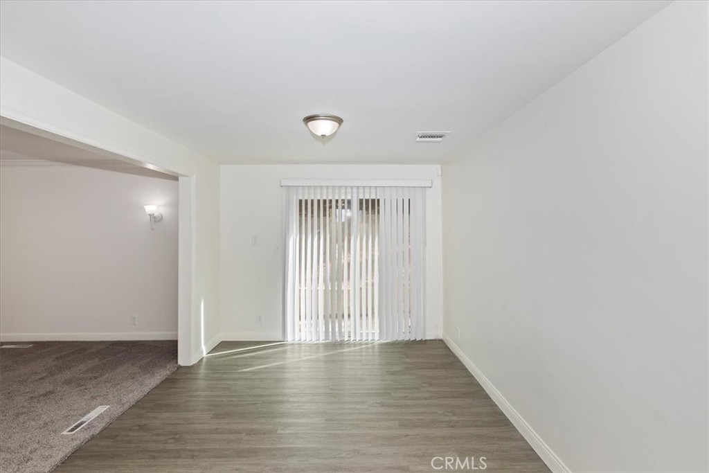 2154 Gainsborough Drive Riverside, CA 92506 - Photo 19 of 43 a view of an empty room with wooden floor and a window