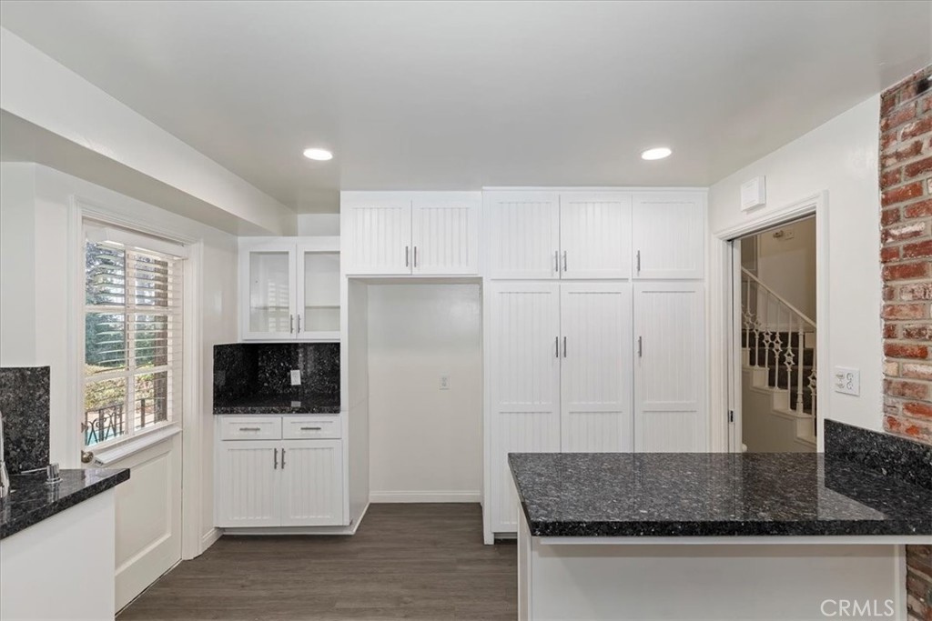 2154 Gainsborough Drive Riverside, CA 92506 - Photo 21 of 43 a kitchen with white cabinets and window