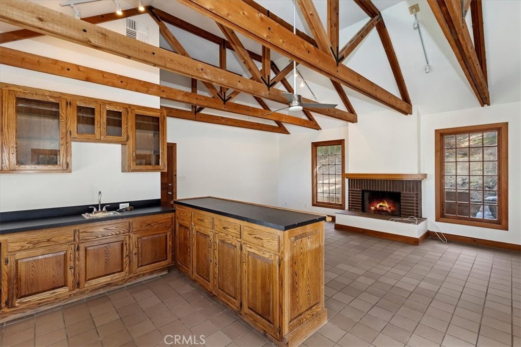 2154 Gainsborough Drive Riverside, CA 92506 - Photo 25 of 43 a hallway with granite countertop a fireplace and a window