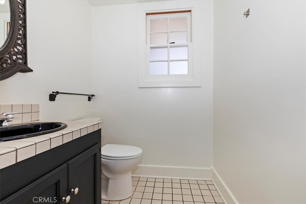 2154 Gainsborough Drive Riverside, CA 92506 - Photo 26 of 43 a bathroom with a granite countertop sink and a toilet