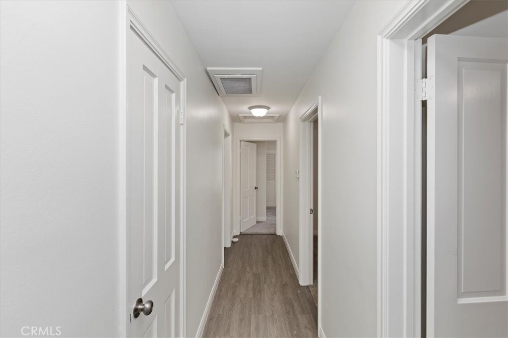 2154 Gainsborough Drive Riverside, CA 92506 - Photo 34 of 43 a view of a hallway with wooden floor