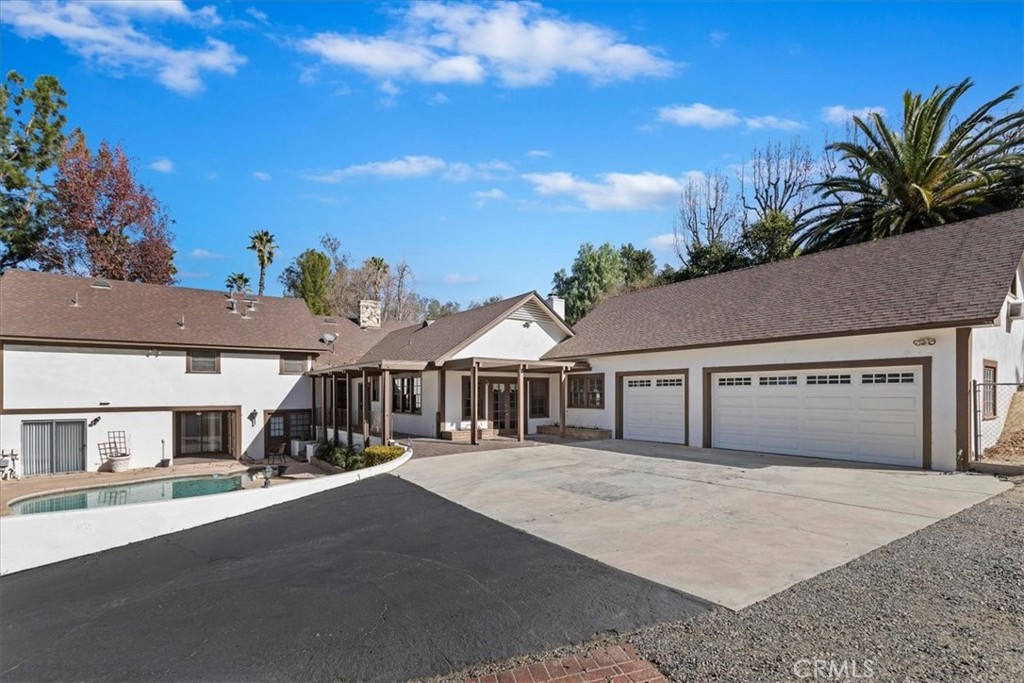 2154 Gainsborough Drive Riverside, CA 92506 - Photo 8 of 43 a front view of a house with a yard and garage