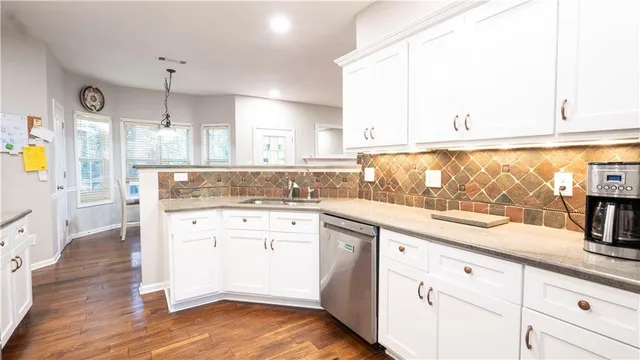 a kitchen with kitchen island white cabinets and white appliances