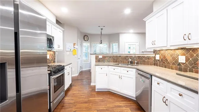 a kitchen with a sink stove and refrigerator