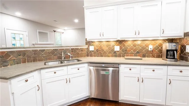 a kitchen with granite countertop white cabinets and white appliances