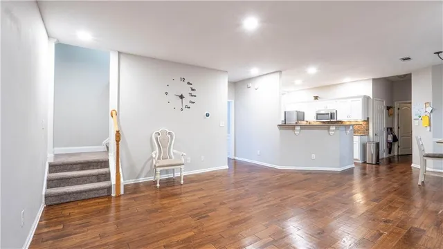 a view of a kitchen with wooden floor and chair