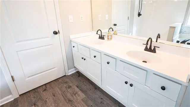a bathroom with double vanity sink and mirror
