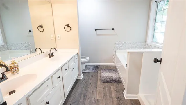 a spacious bathroom with a double vanity sink and a mirror