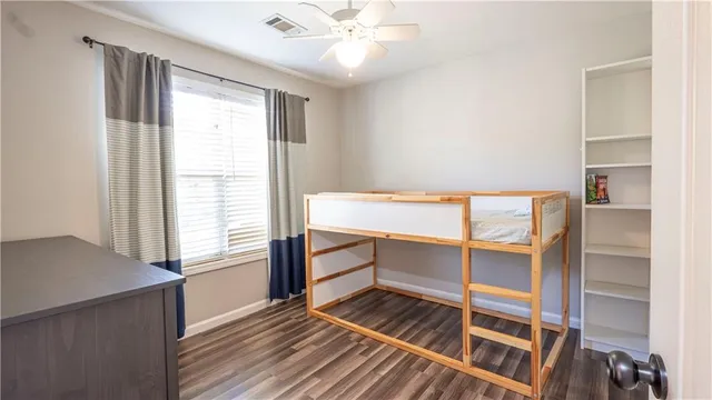 a view of room with window and wooden floor