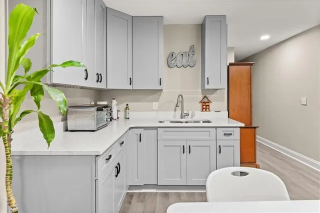 a kitchen with a sink a stove and cabinets
