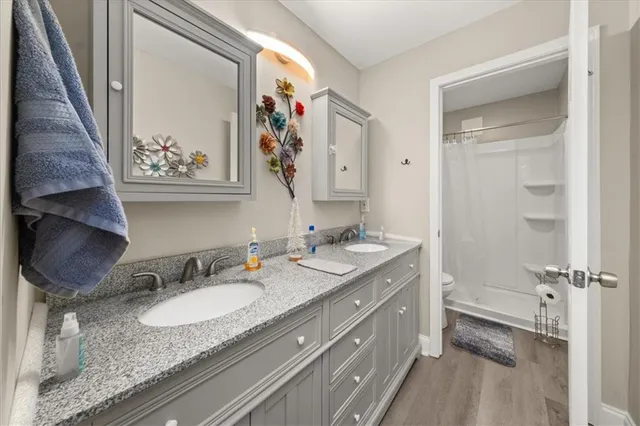a bathroom with a granite countertop sink and a mirror