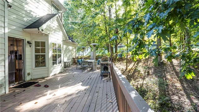 a view of balcony with wooden floor and outdoor seating