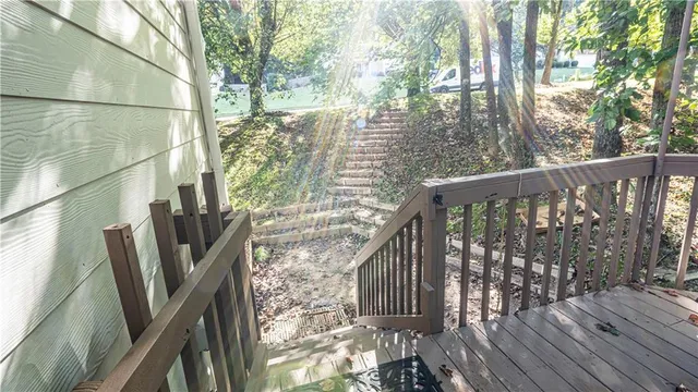 a view of balcony with wooden floor and fence