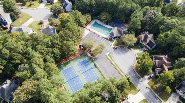 an aerial view of a house with a yard and trees