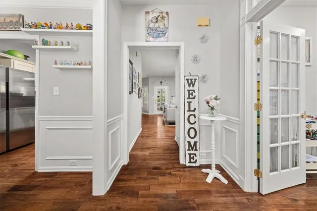 a hallway with cabinets and wooden floor