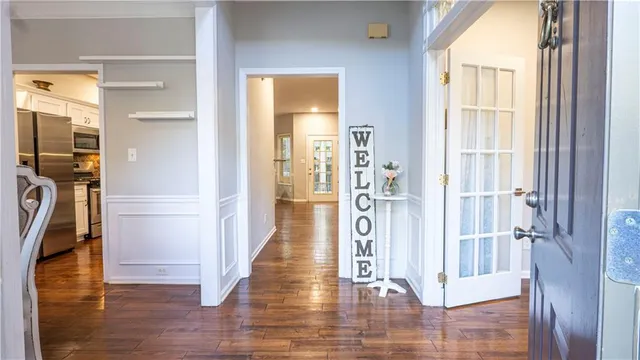 a view of a hallway with wooden floor windows and livingroom