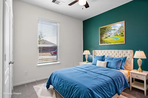 a bedroom with a bed and a painting on the wall