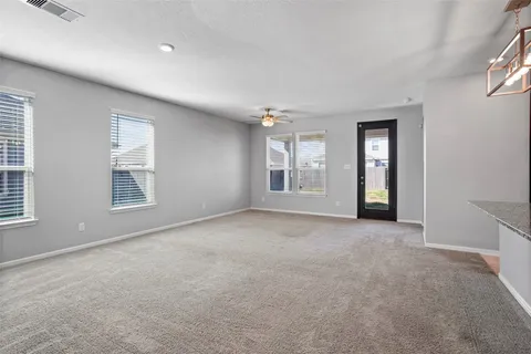 an empty room with windows and closet