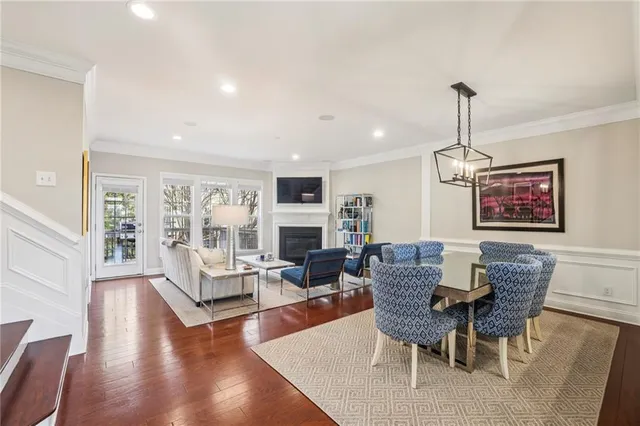 a living room with fireplace furniture and a wooden floor