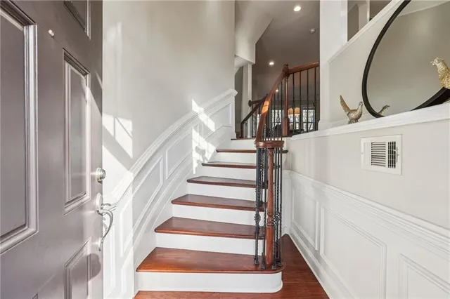 a view of entryway and hall with wooden floor