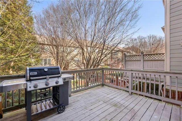a view of a balcony with wooden floor and fence