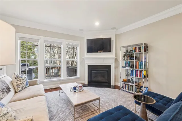 a living room with furniture a fireplace and a flat screen tv