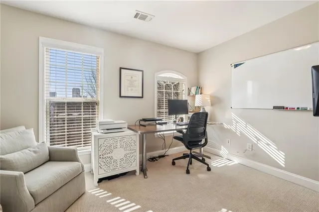 a view of a livingroom with workspace and a couch