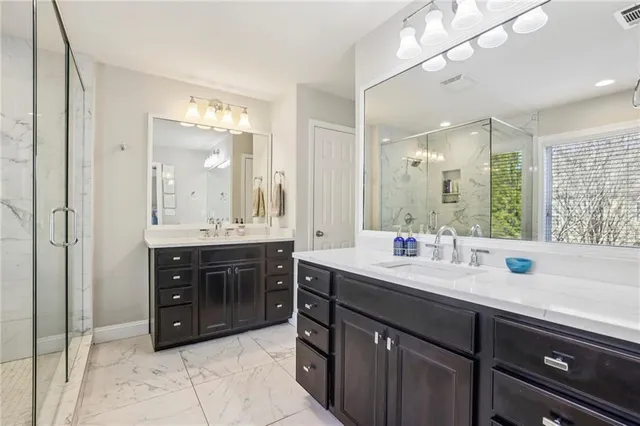 a bathroom with a sink double vanity and a mirror