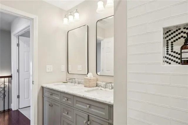a bathroom with a granite countertop sink and a mirror